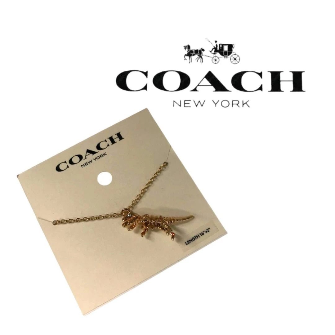 COLLAR COACH SKELETAL REXY – TONO DORADO NUEVO.
